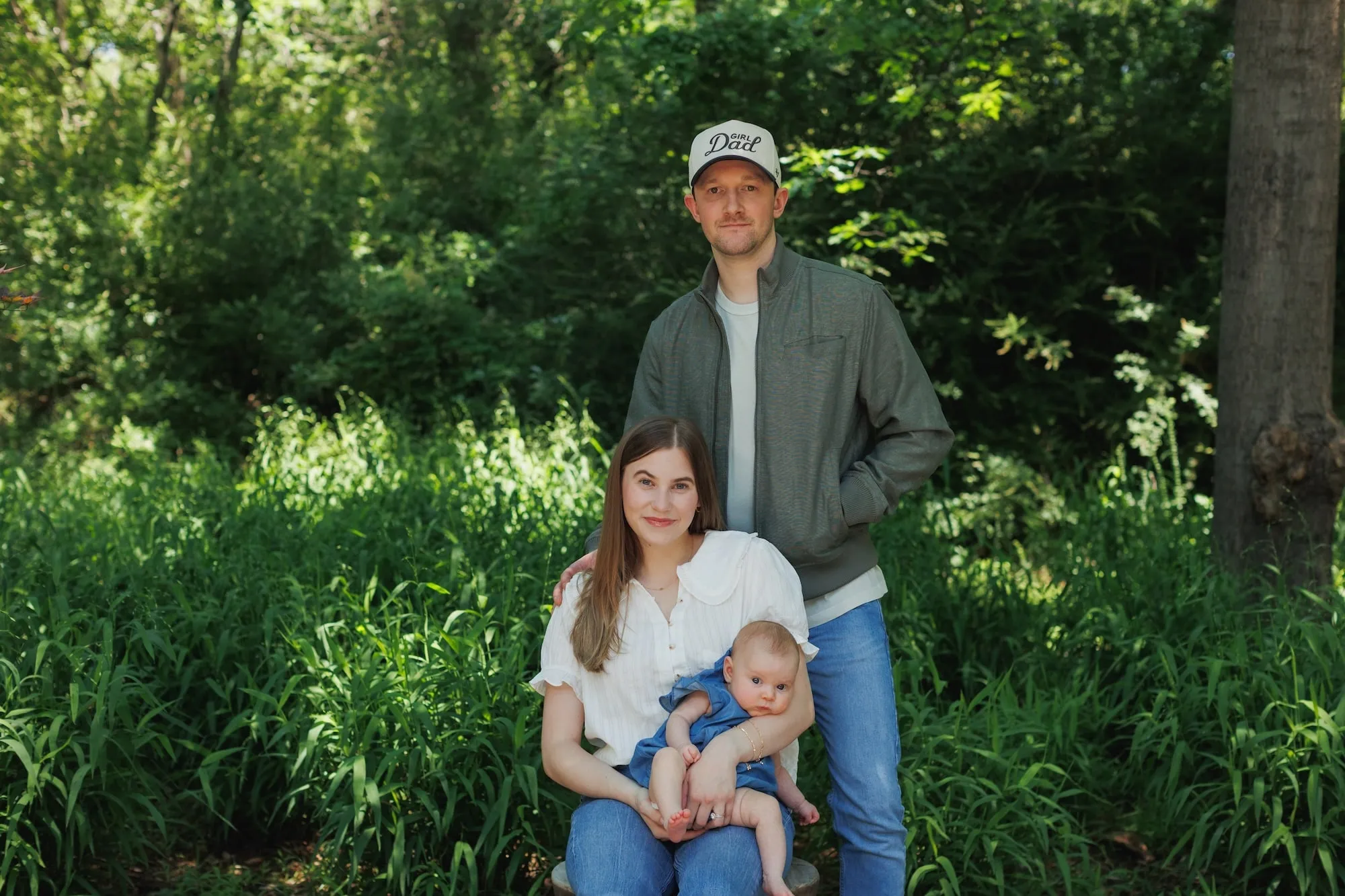 Keeton Storts with Cassidy Storts and their daughter Nora Hayes Storts in an outdoor family portrait