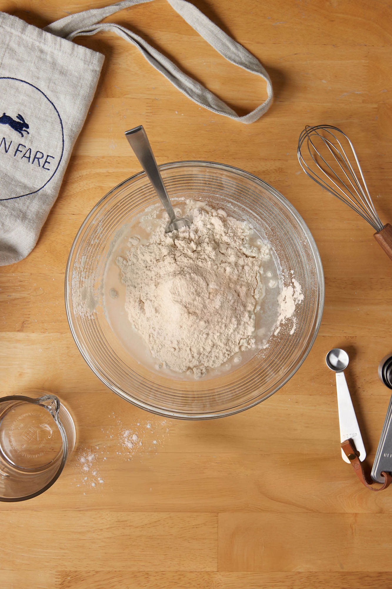 mixing flour water and sourdough culture together in a bowl