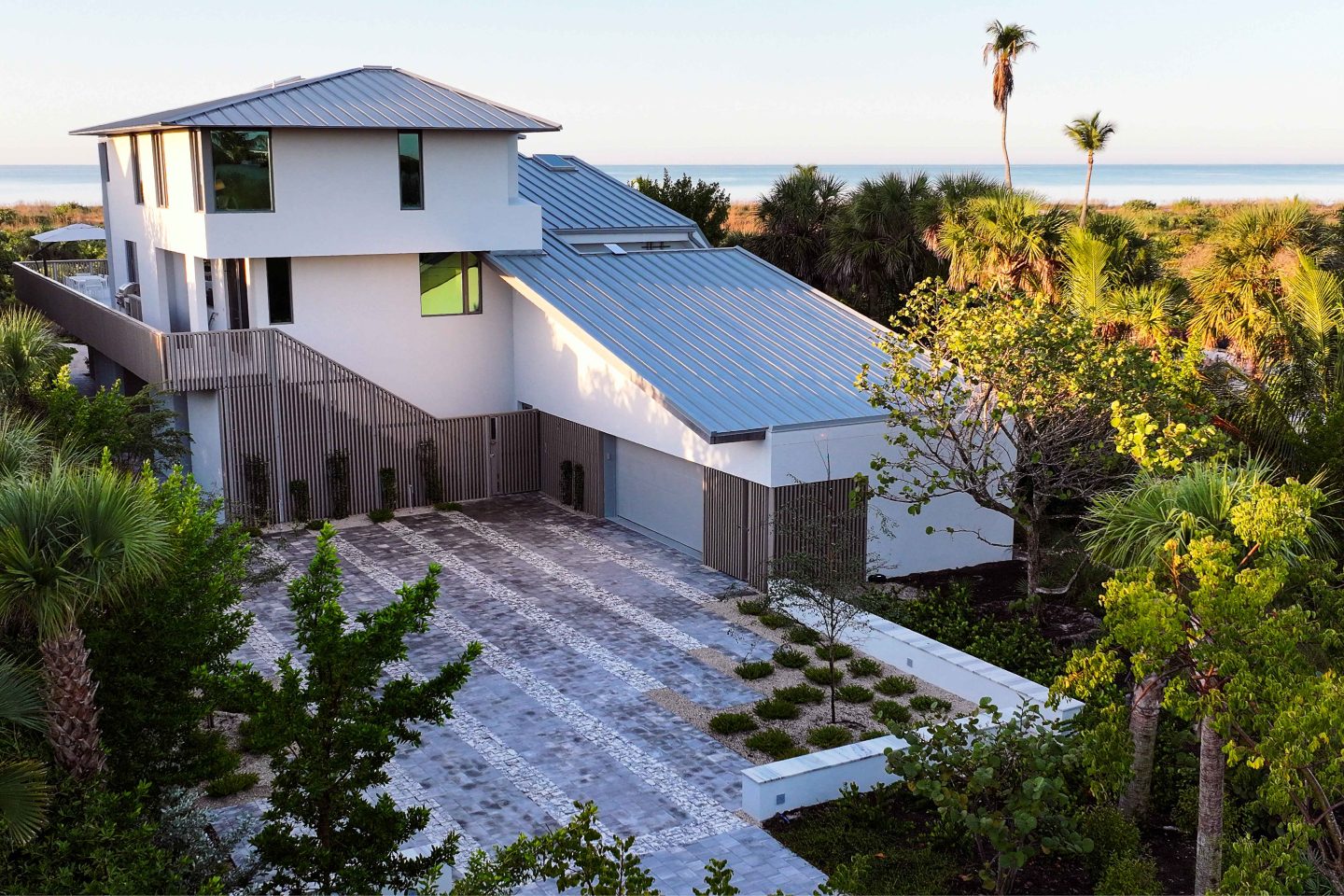 Saltwood Strand residence with striped driveway and coastal vegetation