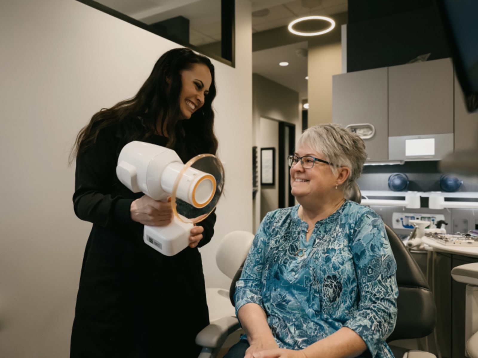 Dentist discussing dental implant treatment with patient at consultation