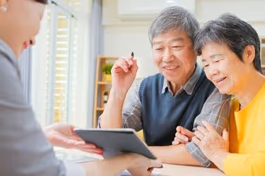 Old couple signing a digital document