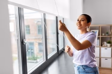 Woman opening curtains for Natural Light
