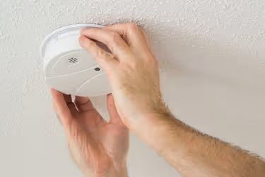 Someone checking the smoke alarm