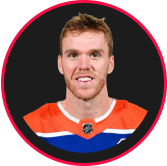 A guy in orange and blue with circle frame and black background