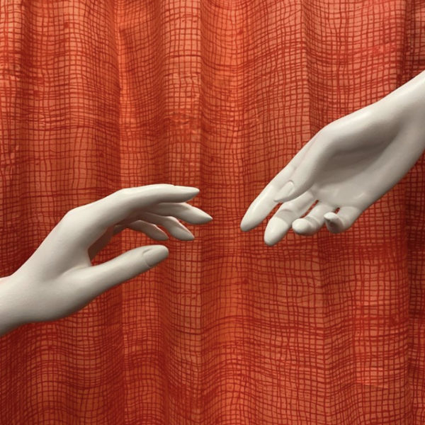 Two mannequin hands reaching for each other