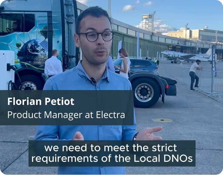 Man wearing glasses and a blue shirt speaking outdoors near a truck and airplane, with text identifying him as Florian Petiot, Product Manager at Electra, and caption about meeting strict requirements of Local DNOs.