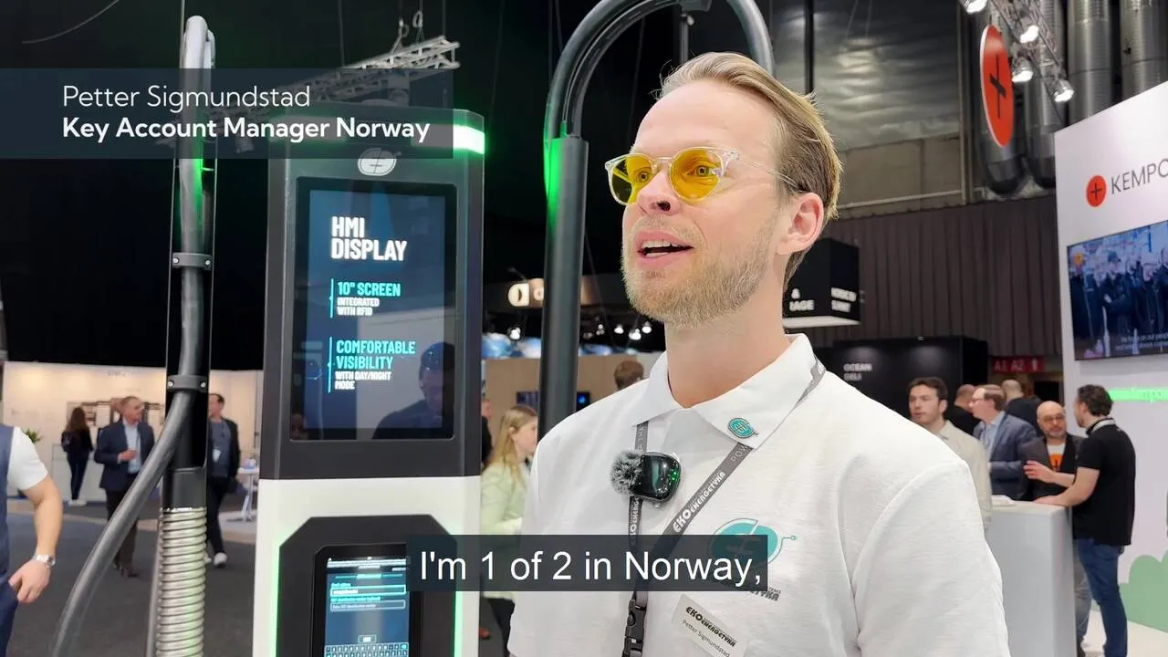 Petter Sigmundstad, Key Account Manager Norway, speaking at a technology exhibition near an HMI display unit.