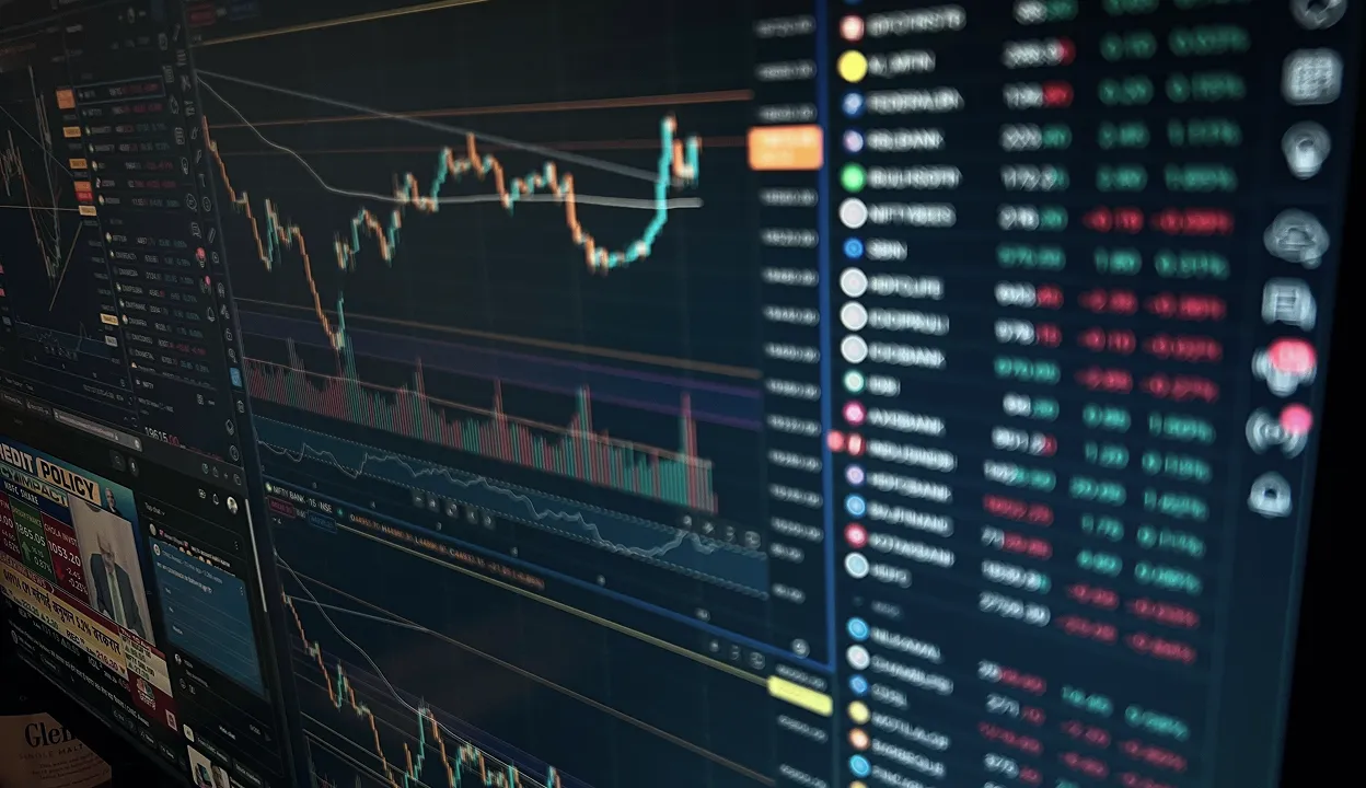 Computer screen showing detailed financial charts and stock market data with graphs and numbers.
