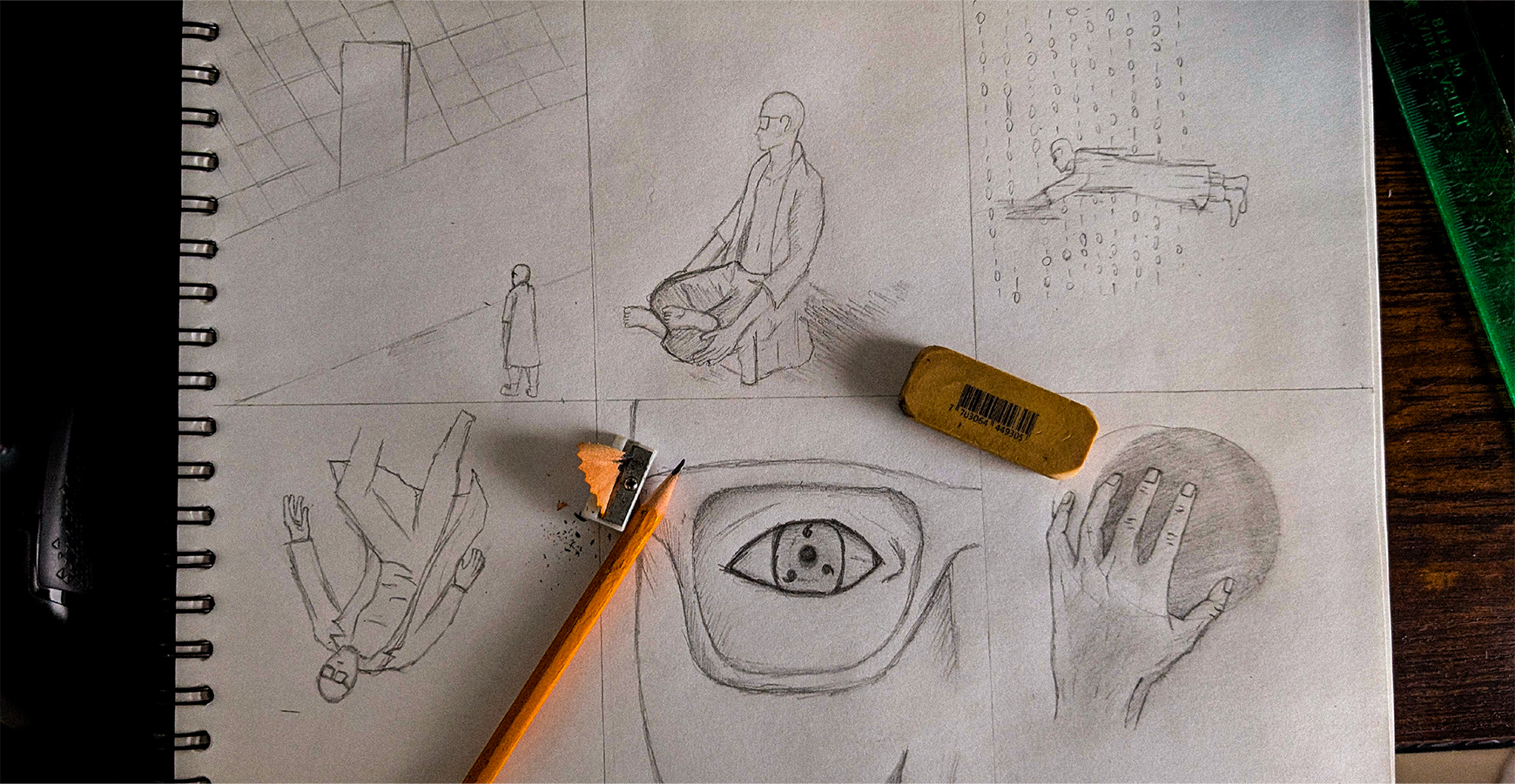 Sketchbook with five pencil drawings of human figures, a large eye, and a hand holding a sphere.