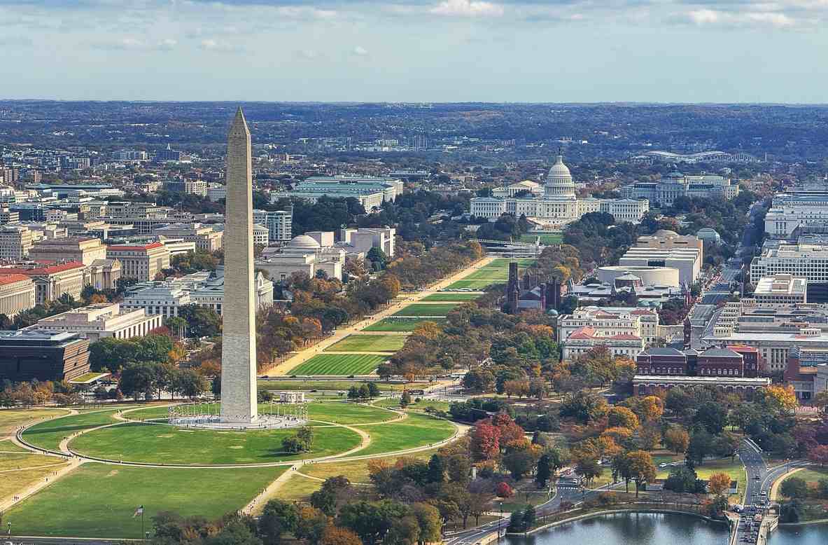 An aerial view of Washington, DC, with the Washington Monument in the foreground and the US Capitol in the background