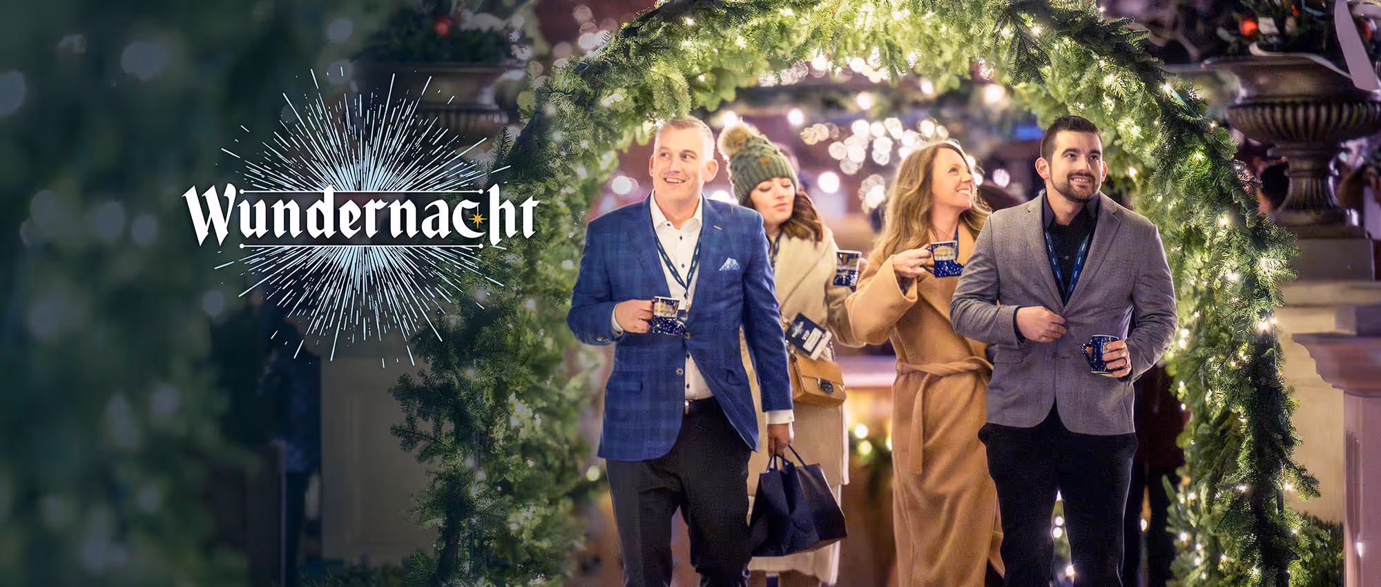 People walking through a christmas garland tunnel at Carmel's Wundernacht event