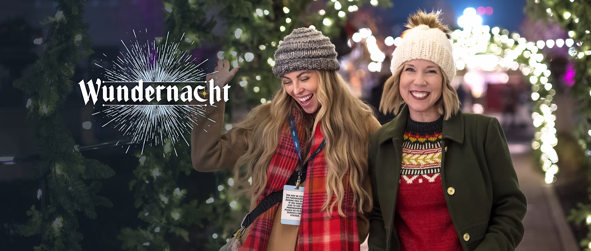 People walking through a christmas garland tunnel at Carmel's Wundernacht event