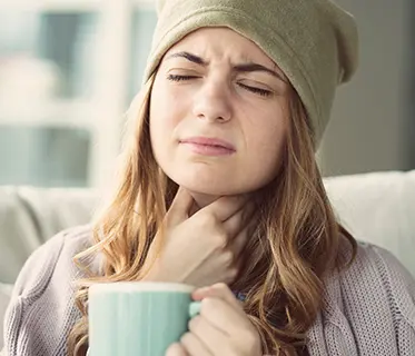 sick person drinking hot beverage