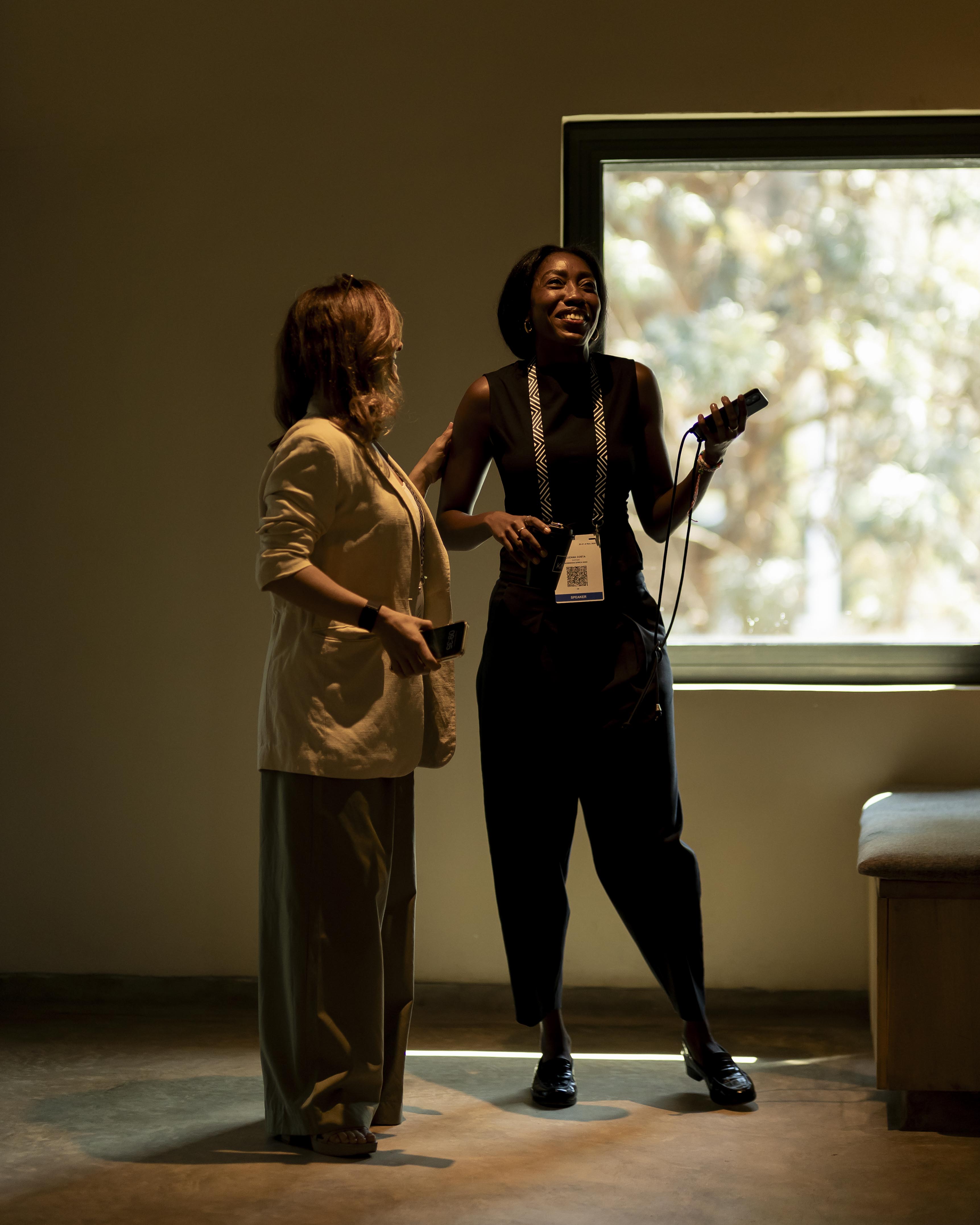 Two women standing indoors near a window at Norrsken House Kigali