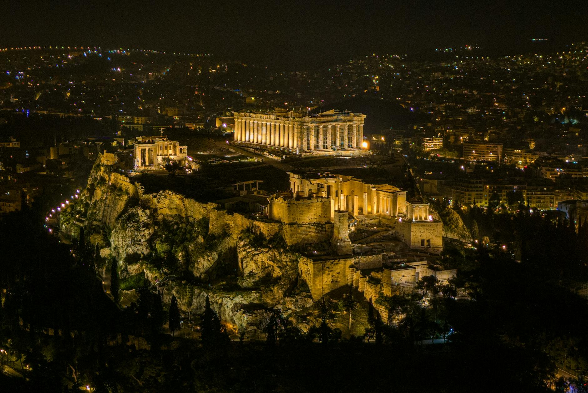 A stunning night aerial view of the illuminated Acropolis in Athens, Greece.