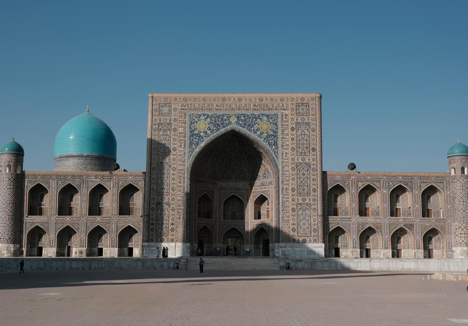 Capture of the historic Registan Mosque in Samarkand, Uzbekistan under a clear blue sky.