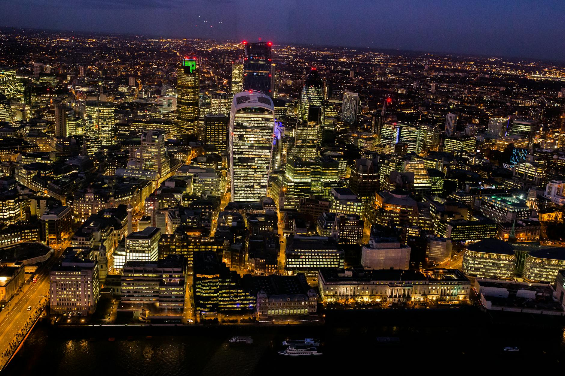 A stunning aerial view capturing London's illuminated skyline at night.