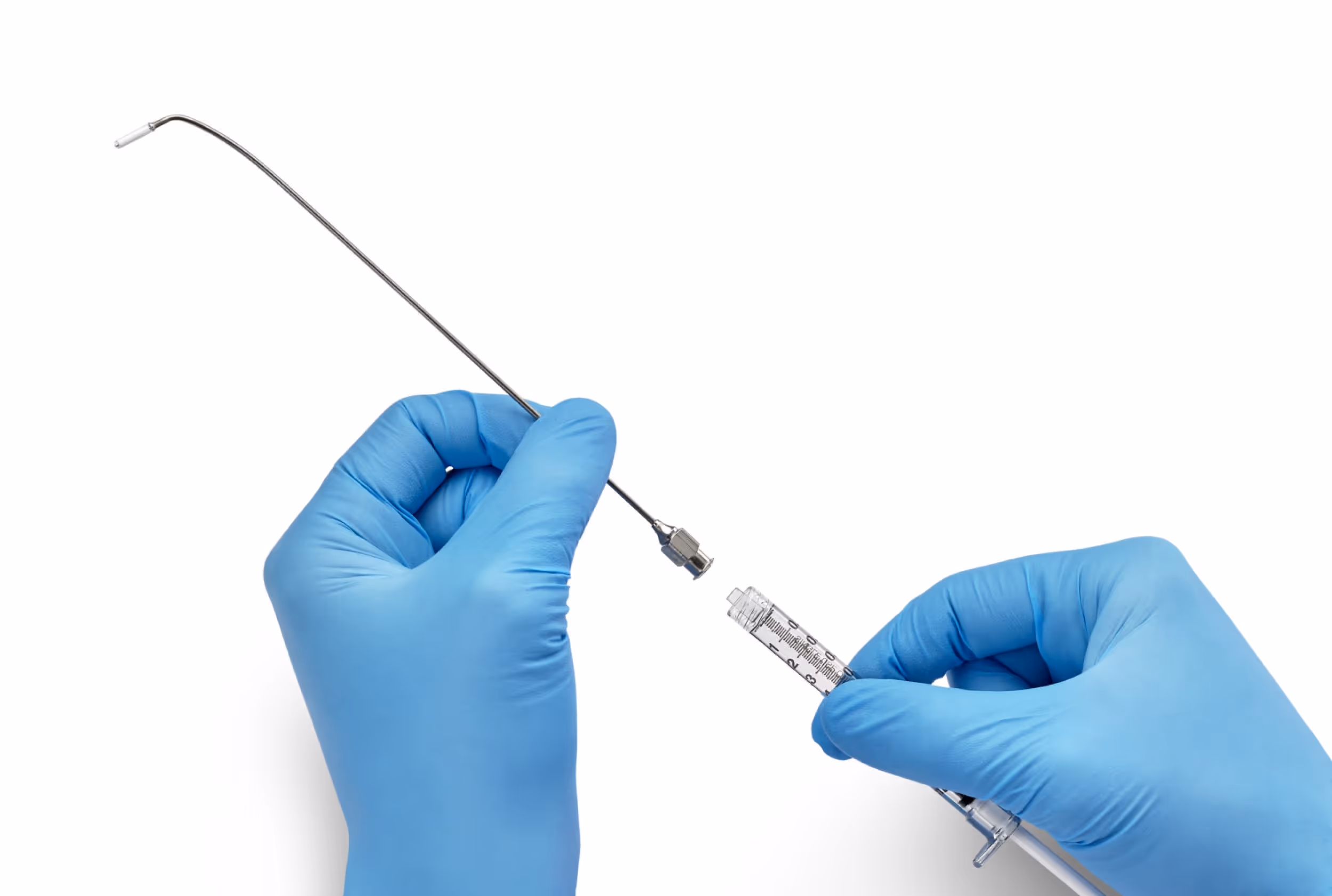 Hands wearing blue gloves holding a curved device that places a Vectra device.