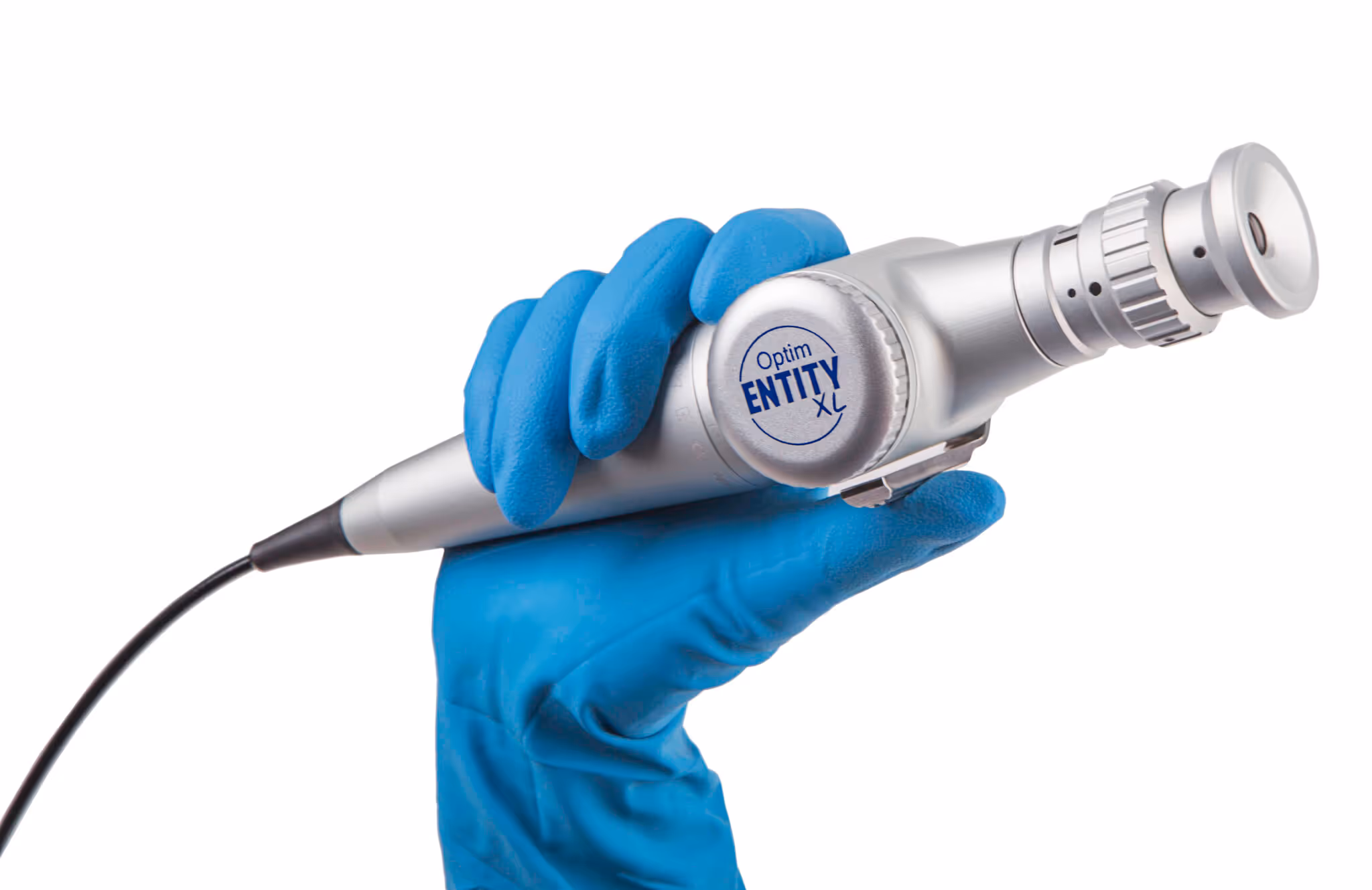 Hand wearing blue glove holding a silver medical device labeled Optim Entity XL.