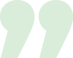 Two large pale green quotation mark symbols on white background