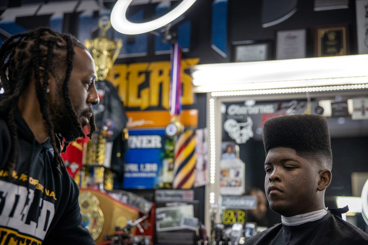 Barber Nas viewing his work