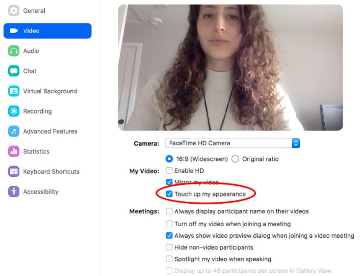 Zoom video settings menu showing 'Touch up my appearance' option checked with a woman’s video preview.