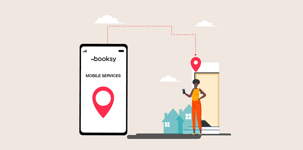 Illustration of person using phone with Booksy app showing mobile services location pin.