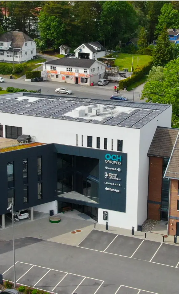 An aerial view of a building with solar panels on the roof.