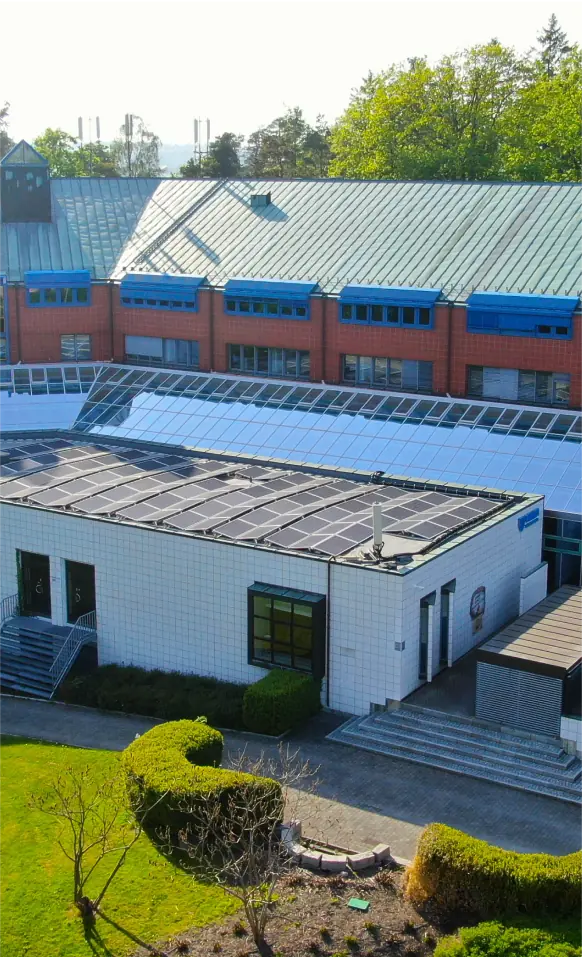 An aerial view of a building with a green roof.