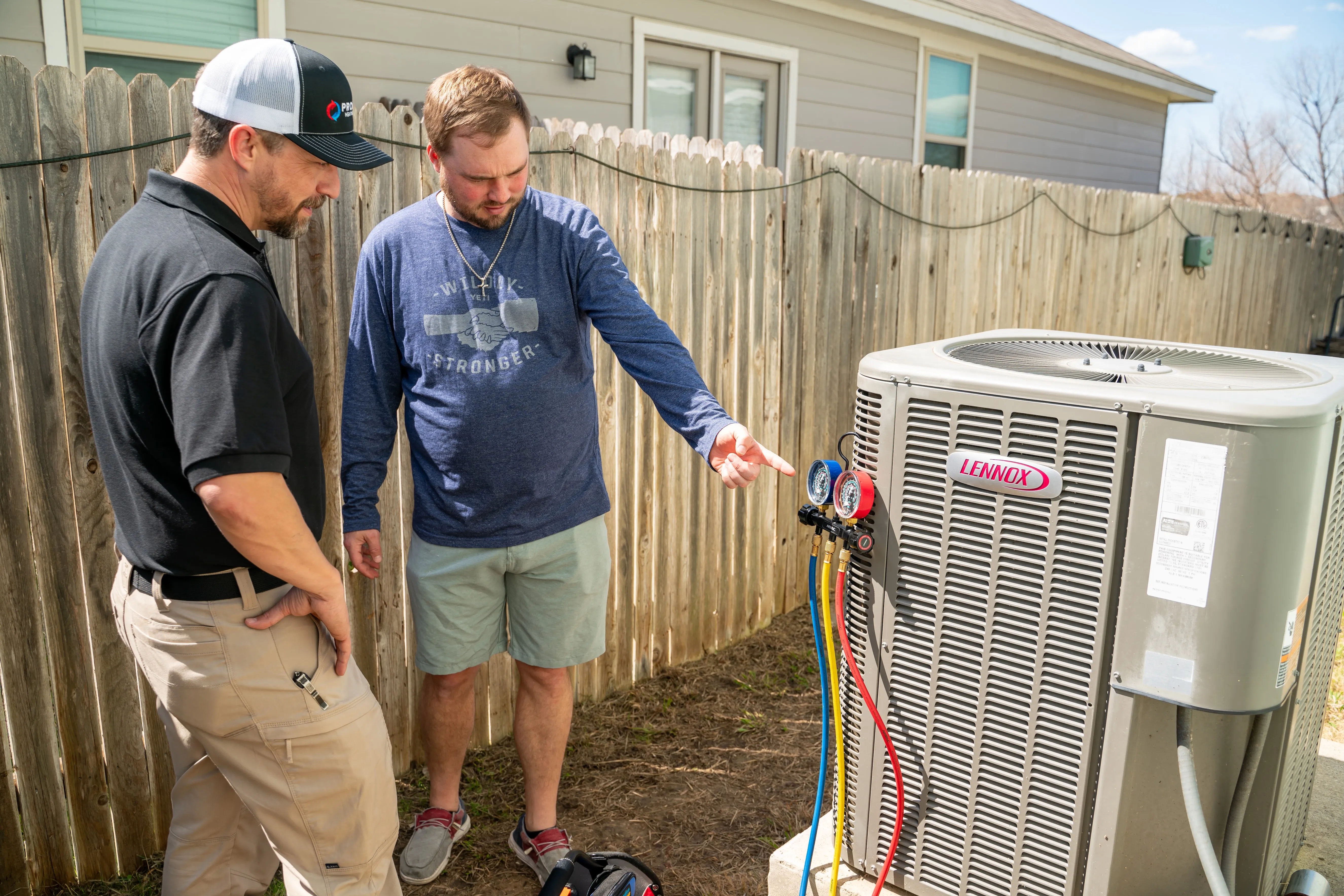 Technician chatting about the AC unit with customer.