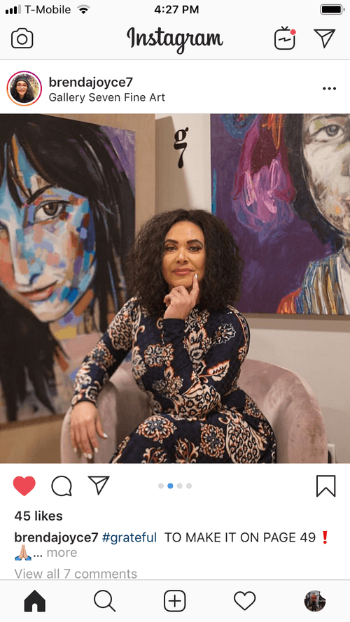 brenda joyce art gallery owner with my paintings behind her