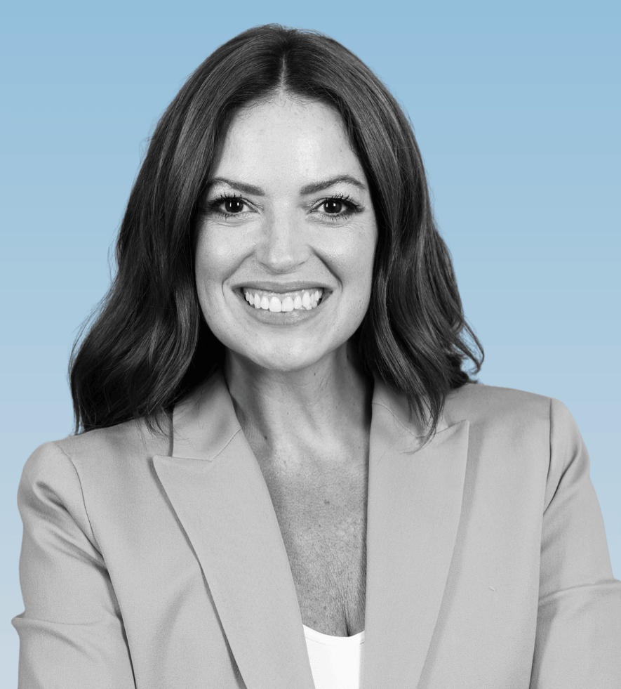Ashley Wilson, account director at Julie Parker Communications, smiles in a blazer against a light blue background.
