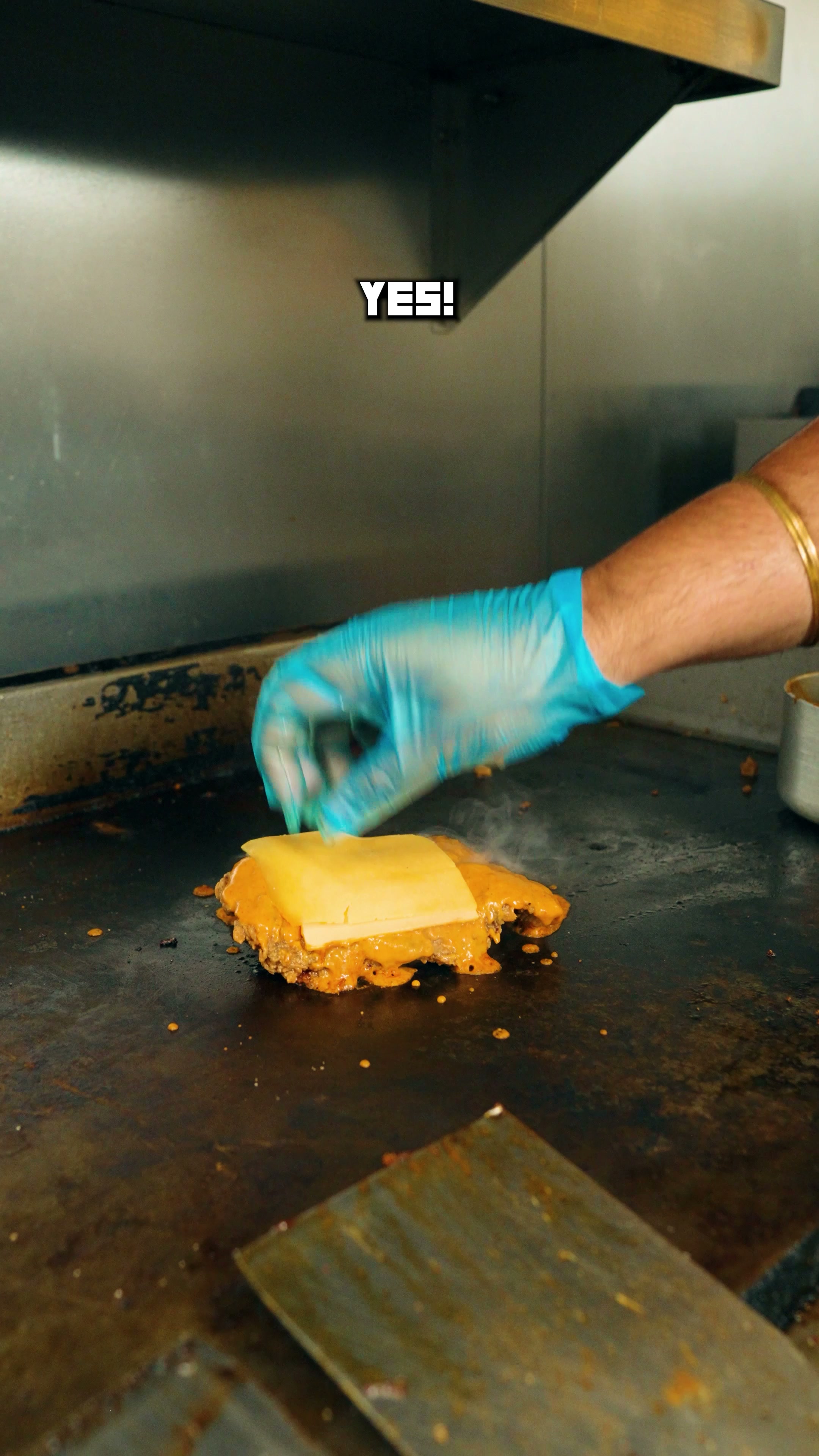 Cookin Lab smash burger being cooked on the griddle