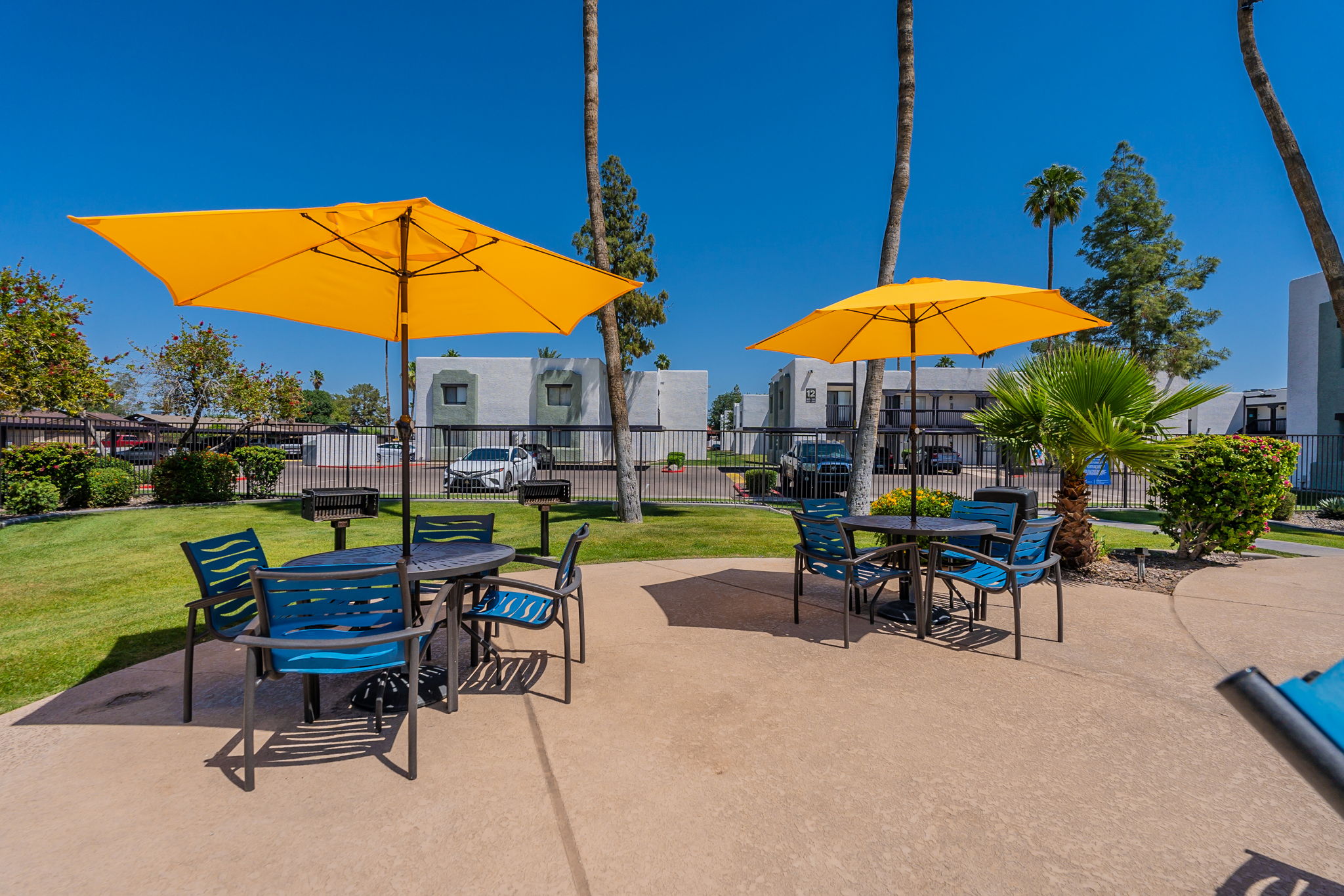 Poolside picnic tables and umbrellas.