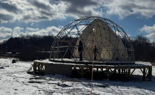 Geodome under construction on platform in snow at Star Farm