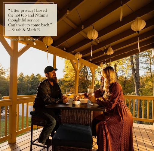 Couple sharing wine on the deck at Immersive Escapes, with guest review overlay