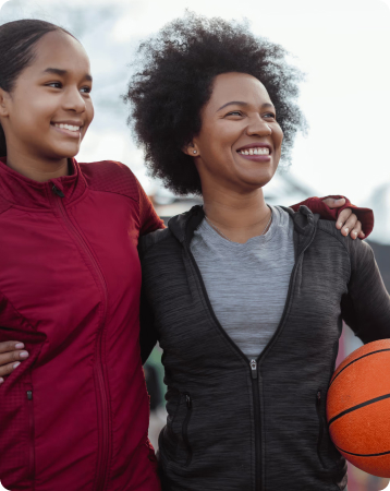 A mother and daughter smiling together