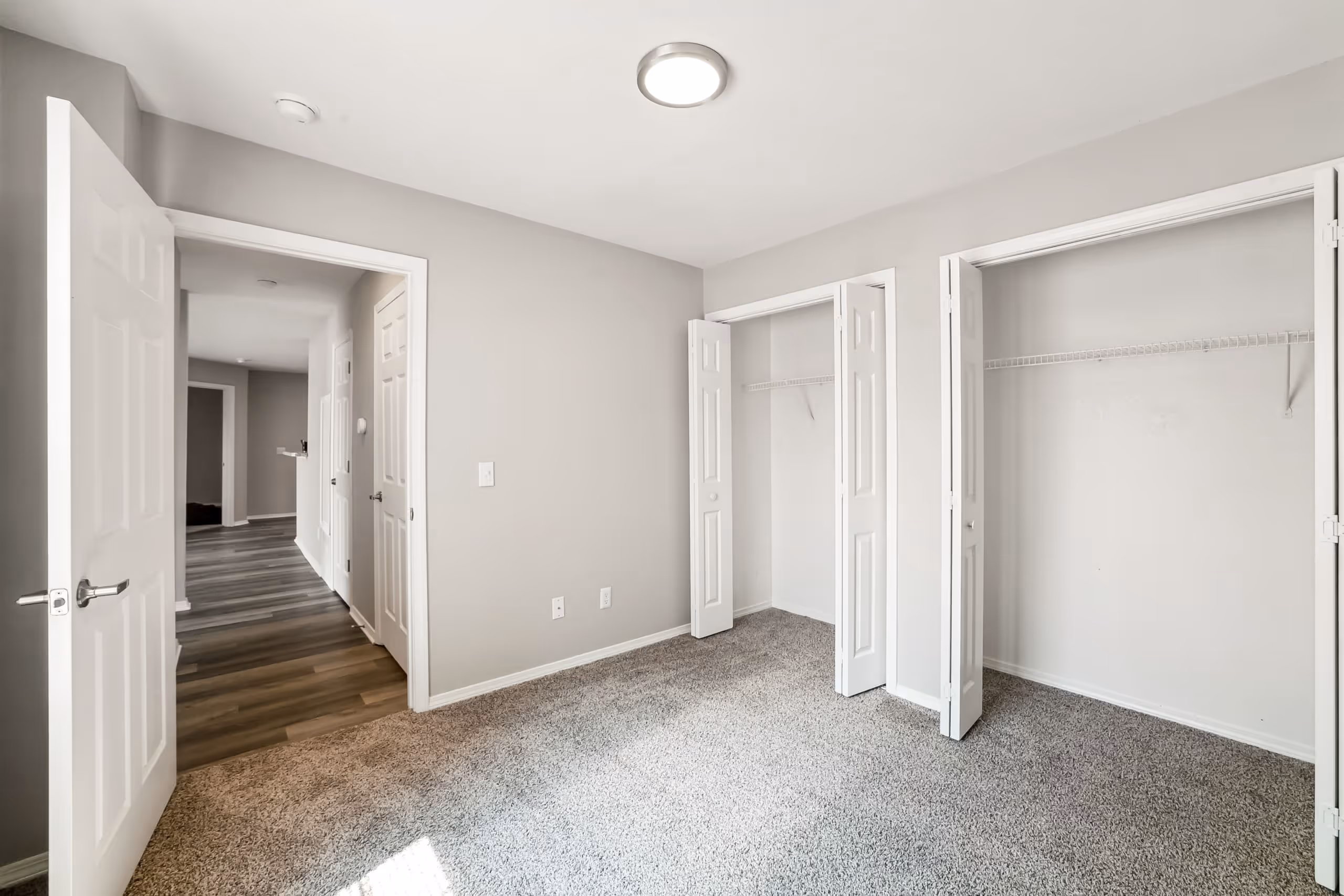 Empty bedroom with open closets