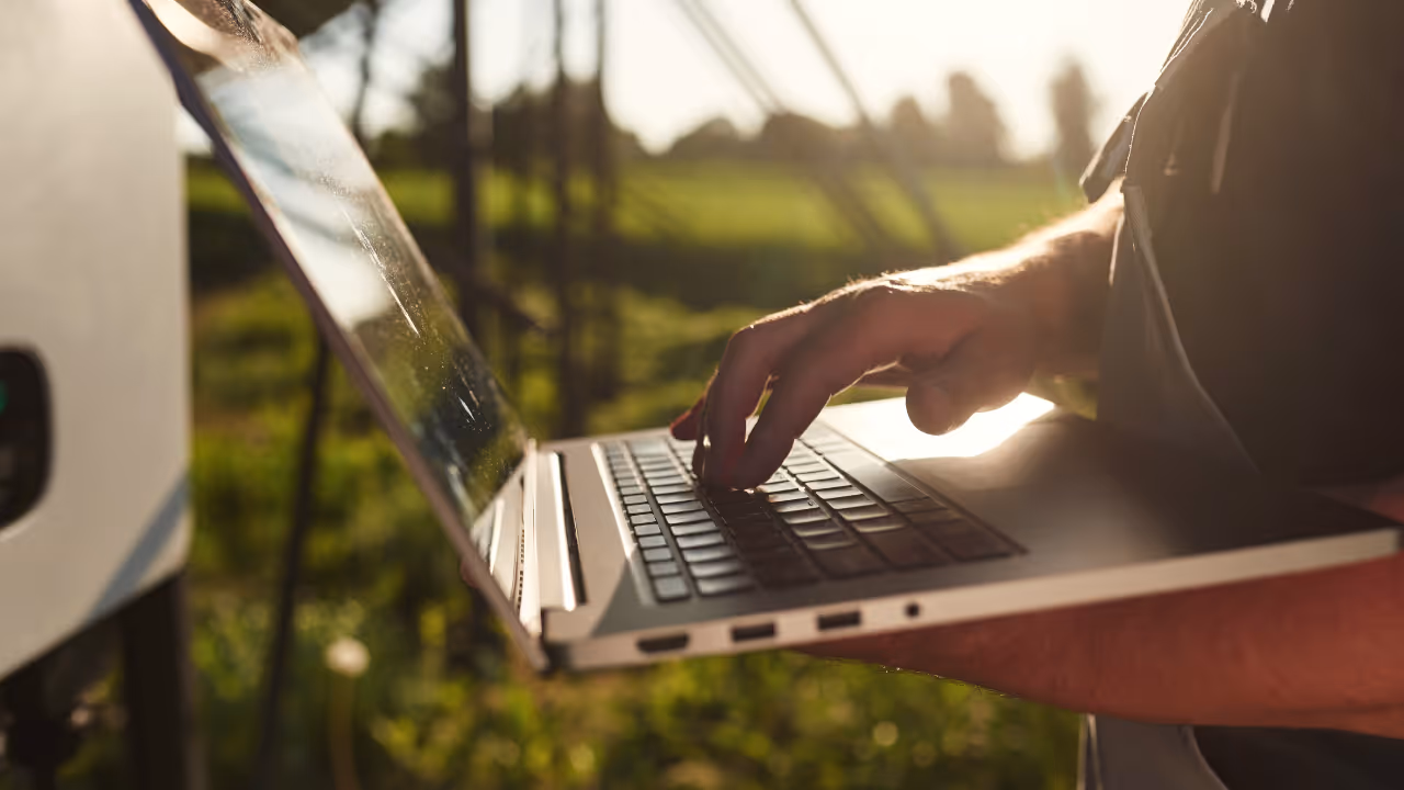 Farmer typing on laptop