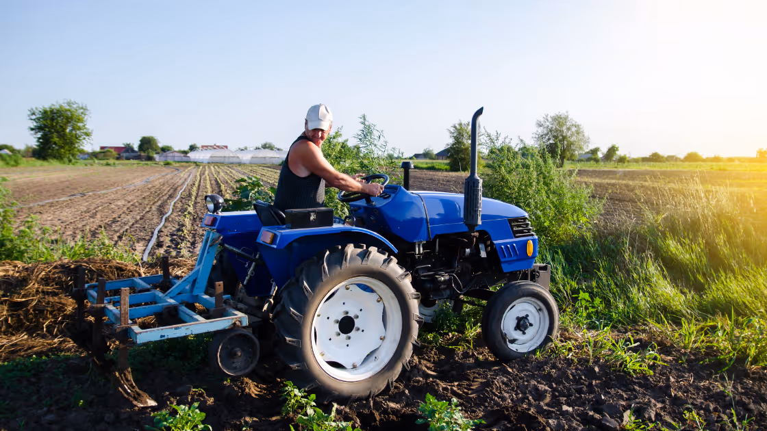 Woman on tractor on a field