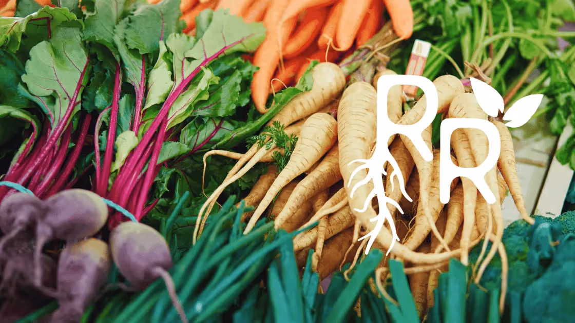 Farm fresh produce such as beets and carrots with region roots food hub logo