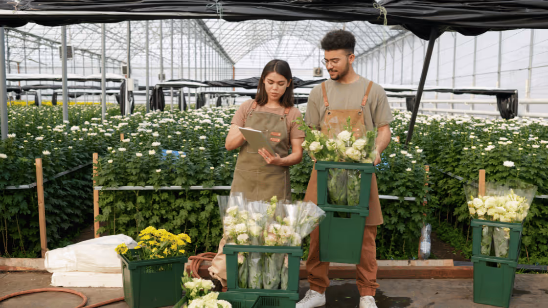 Two workers in flower warehouse.