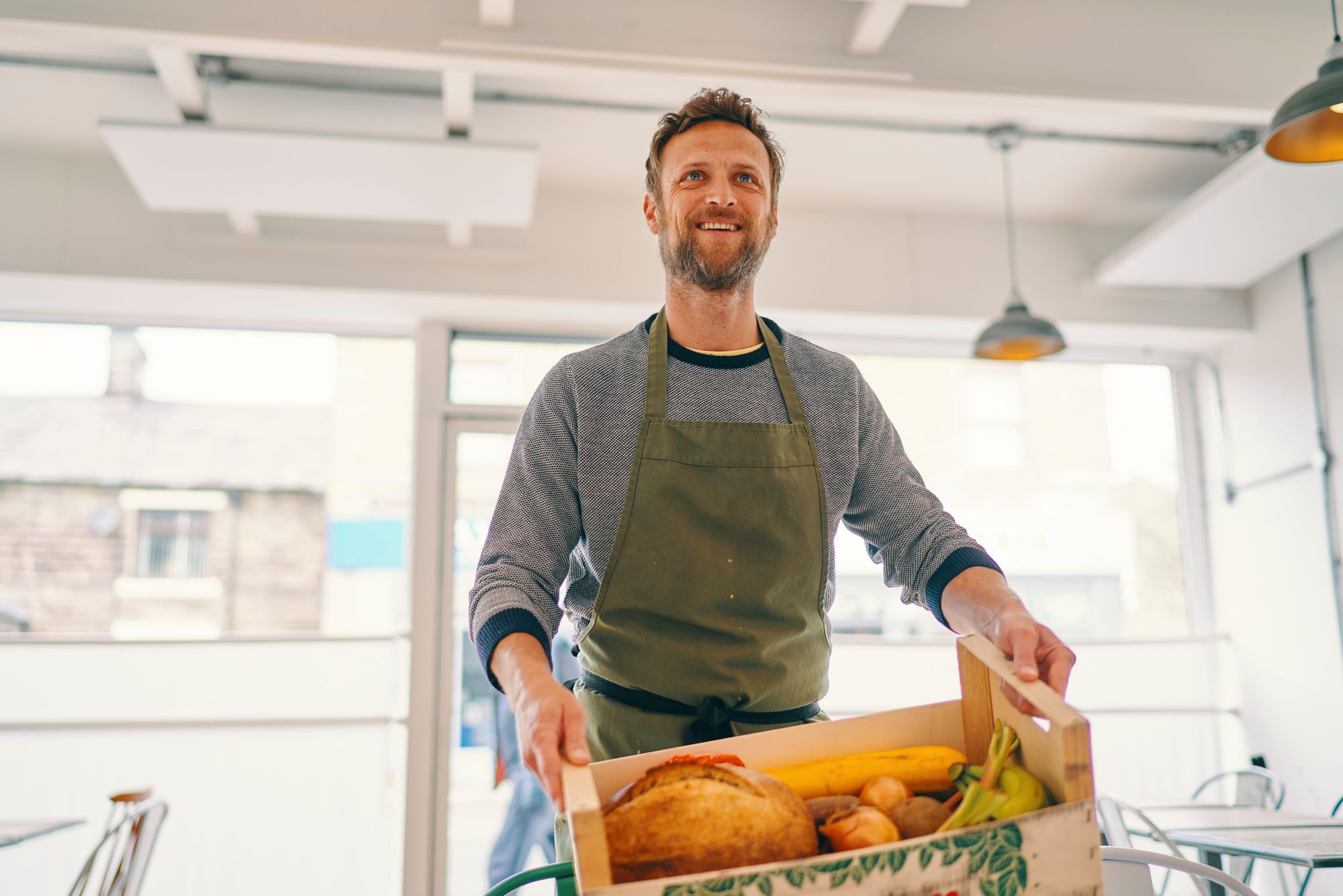 Food Hub manager holding crate.