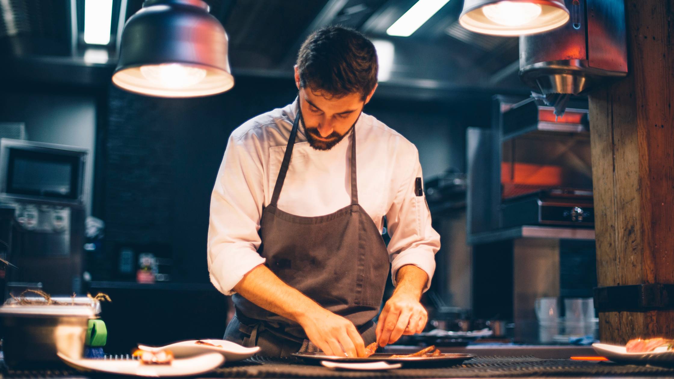 Chef prepping dishes in a restaurant.