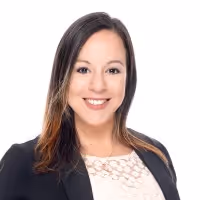 Smiling woman with straight shoulder-length hair wearing a black blazer and white top with a lace pattern.