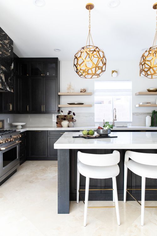 Kitchen design with gold pendants and black cabinets
