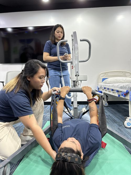 Groworx trainees practise assisted patient transfers using a hoist