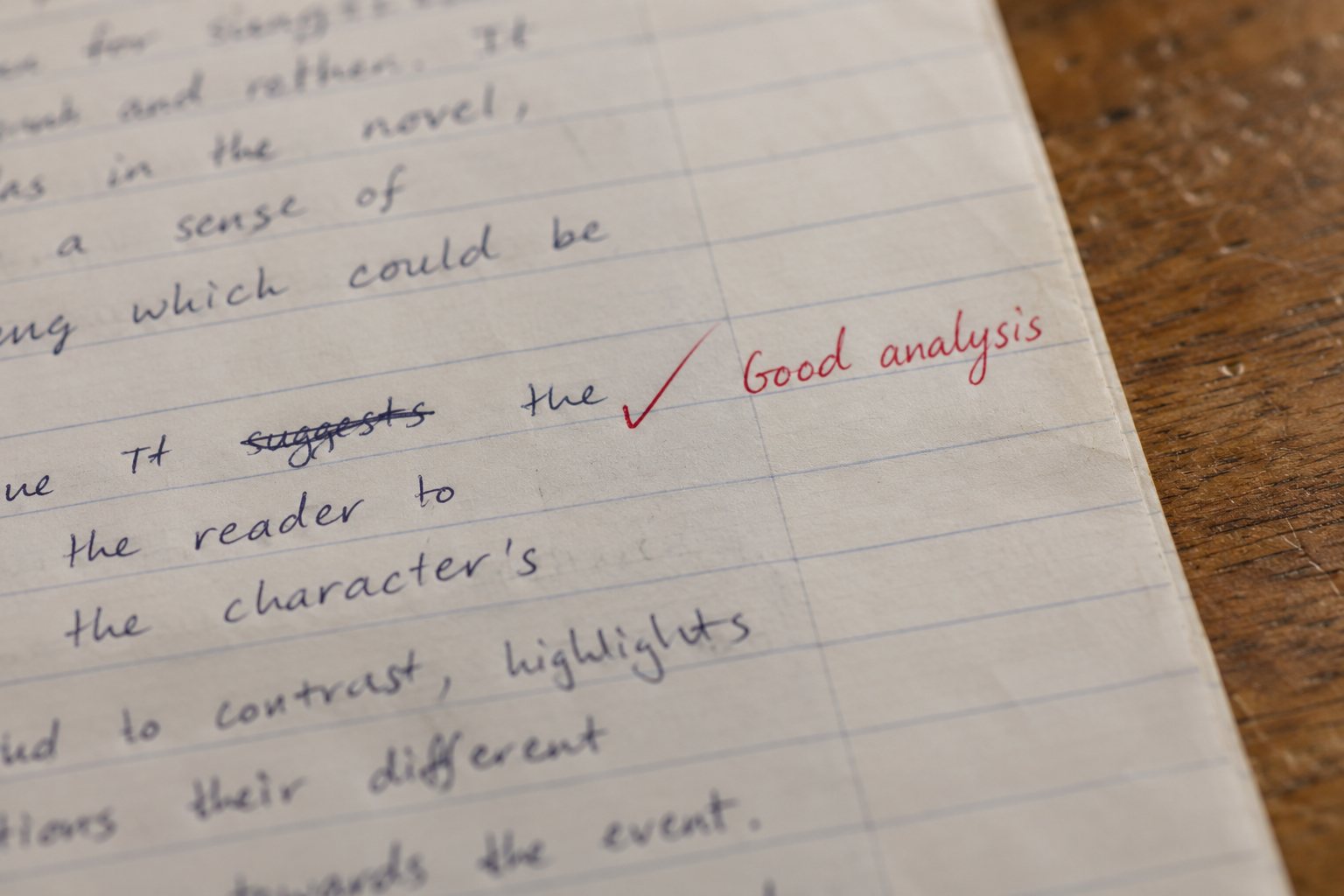 A close crop of a handwritten Year 12 English paragraph with a red tick and the words Good analysis in the margin
