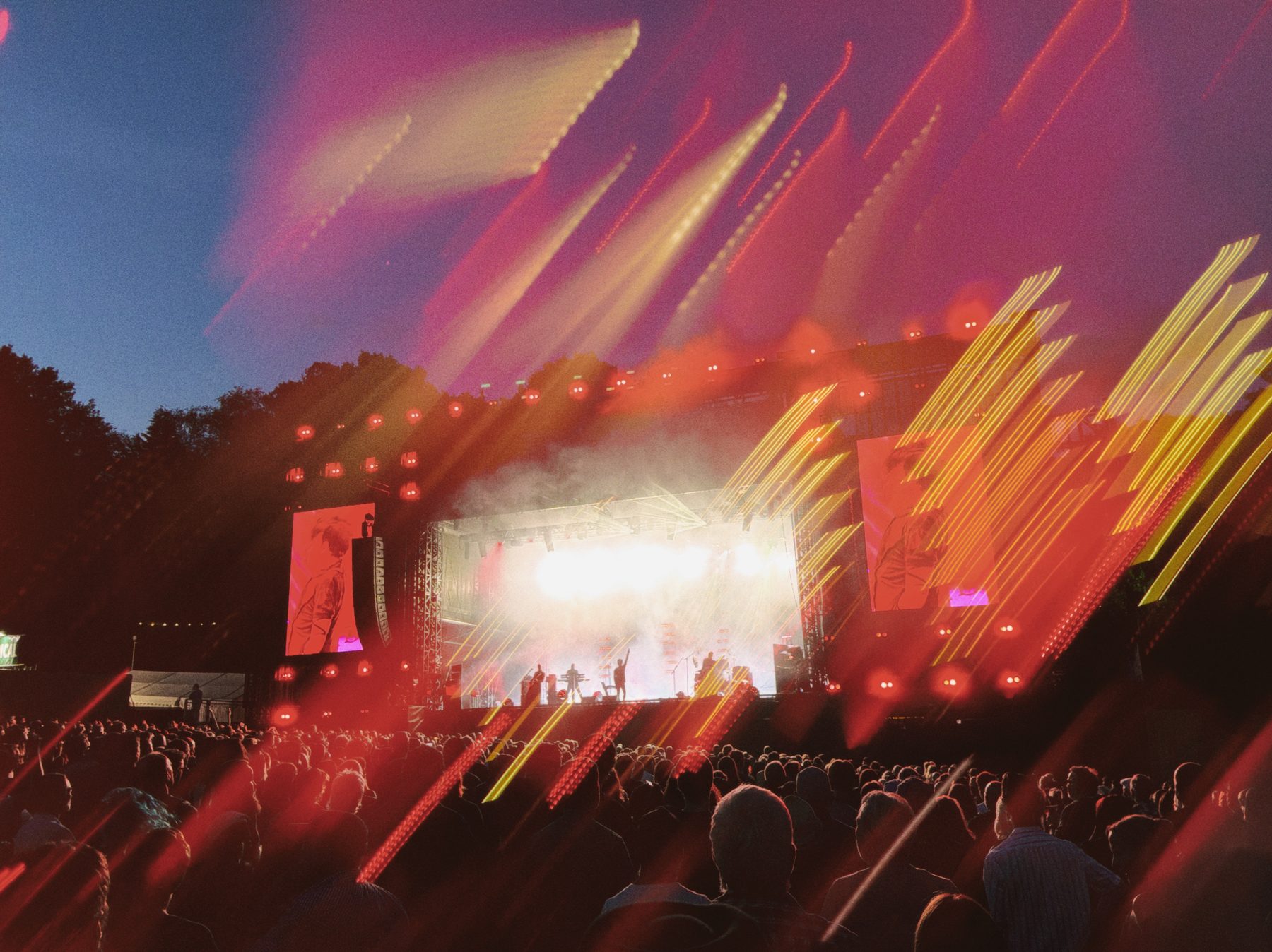 A live music stage where the lights are pulled into sweeping orange and red trails