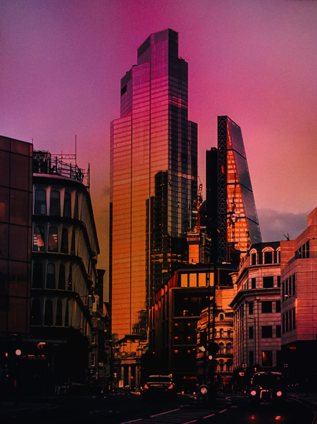 City towers at dusk washed in deep pink and orange